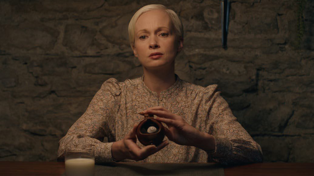 Carolyn Bracken portrays a haunting presence in the film. Haunted house, ominous exterior, and the unexpected death - Image 2.