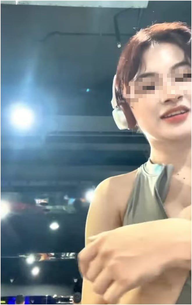 Encountering an incident while training, a female gym-goer excitedly records a clip to post on social media 4 Female gymer excitedly recording clip during workout