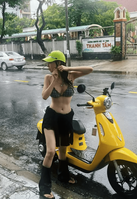 The buzz around images of a pretty girl in a bikini, innocently checking in on the street: Attractive outfit but inappropriate 3 Beautiful girl in bikini enjoying her time during the rain.